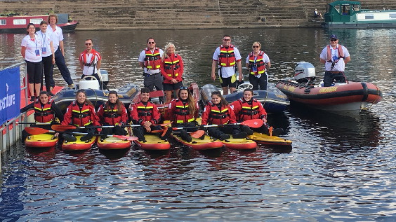 Team of lifeguards in rescue boats and with surf skis