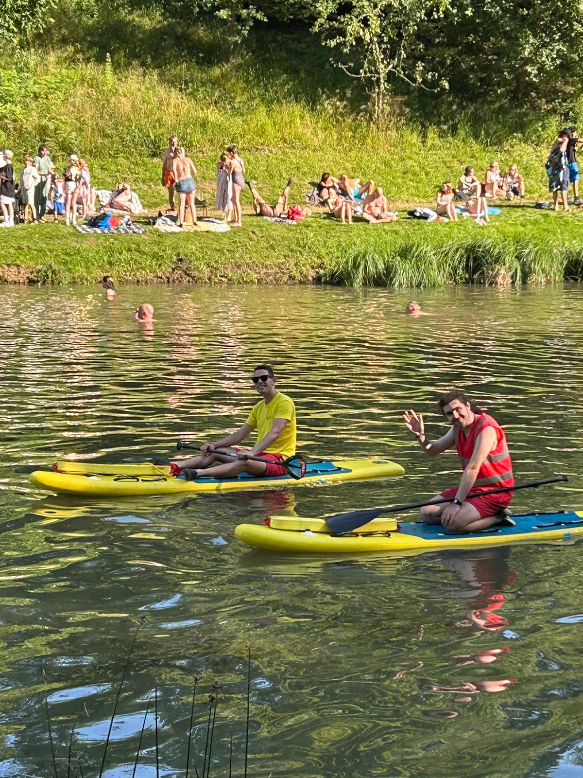Lifeguards on paddleboards on lake