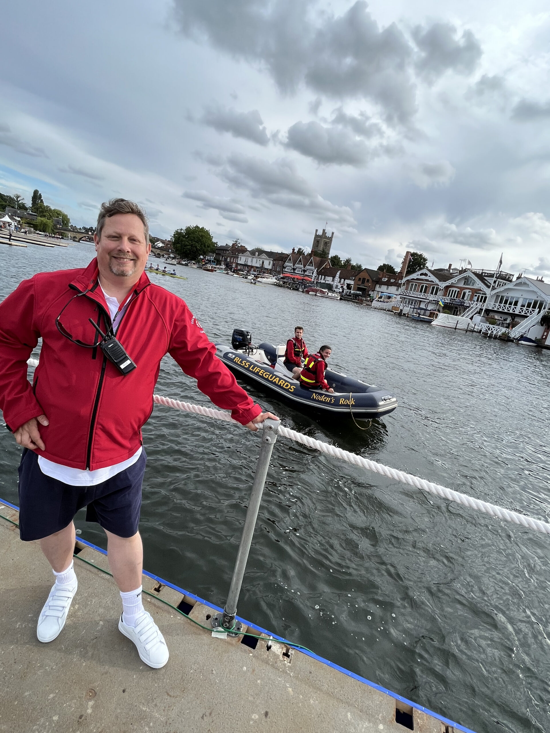 Lifeguard next to water with safety boat in the background