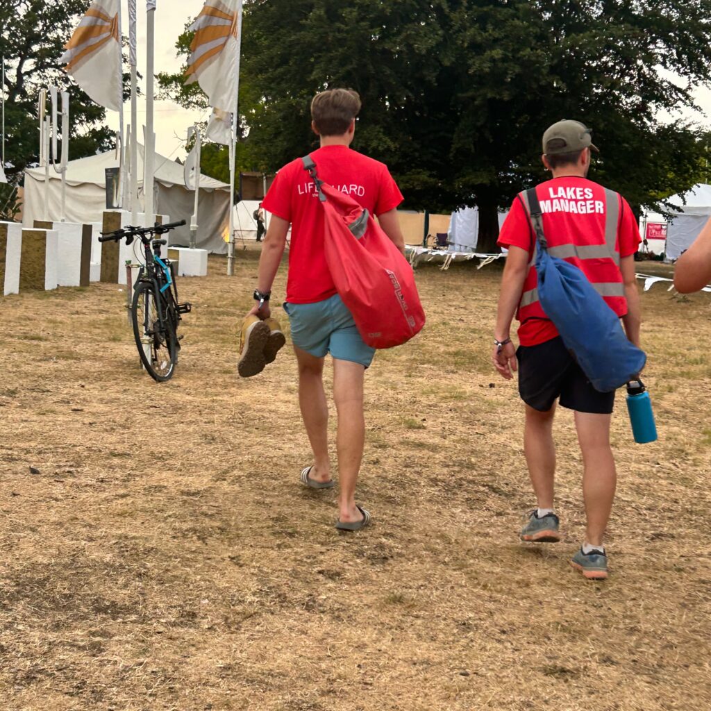 Lifeguard and lakes manager walking on site at Wilderness festival