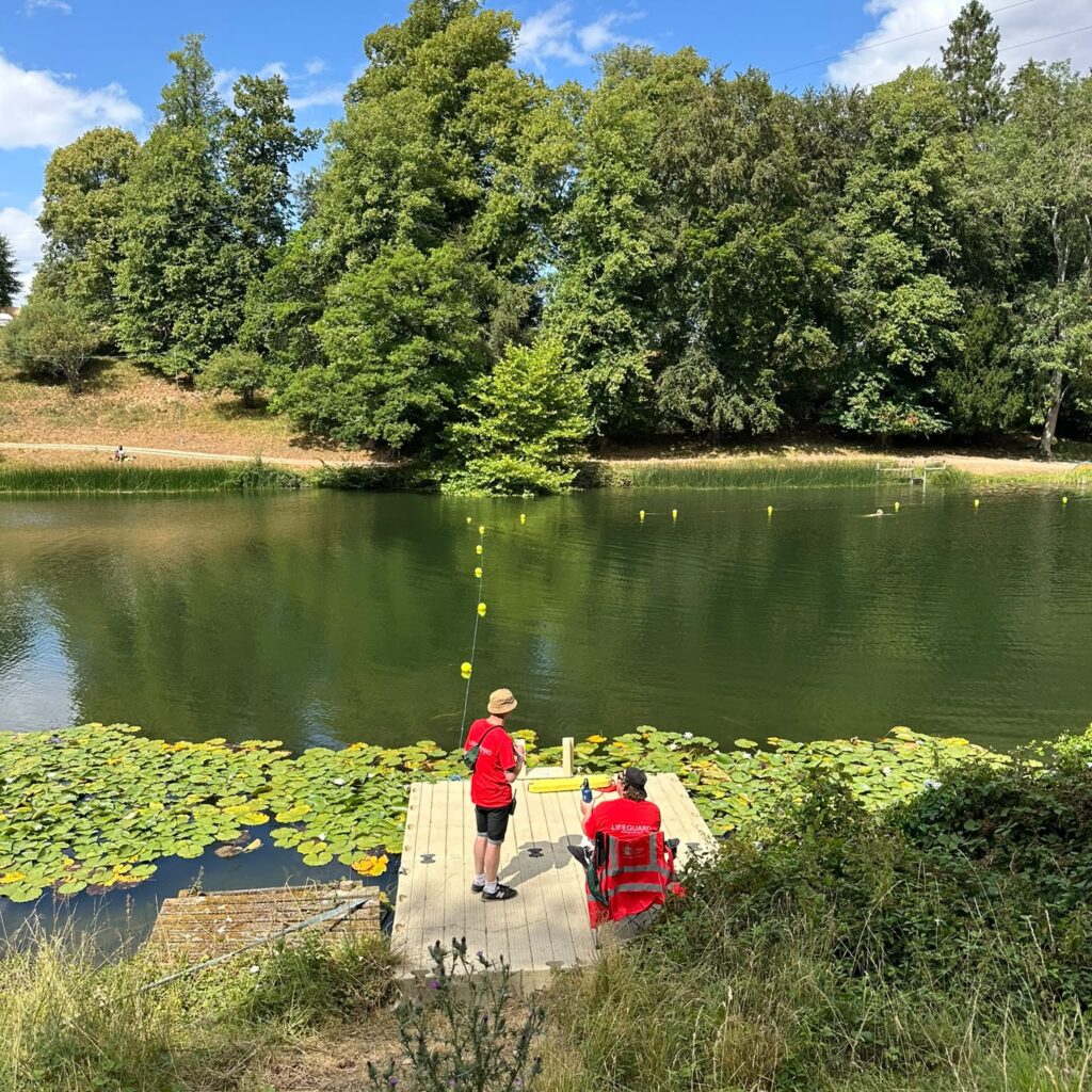 Lifeguards standing by lakeside of Lake Superior at Wilderness festival