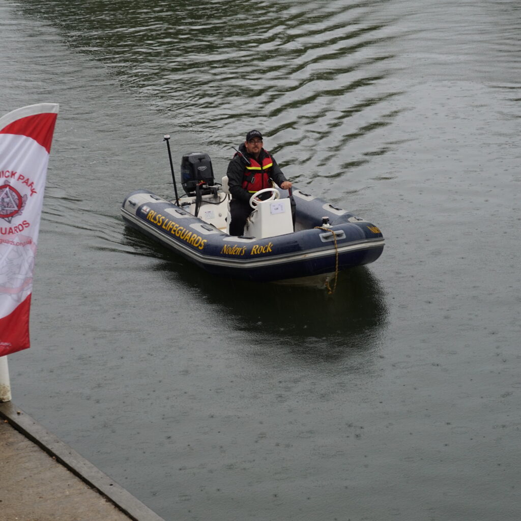 Safety boat on river Thames during Reading festival in the rain
