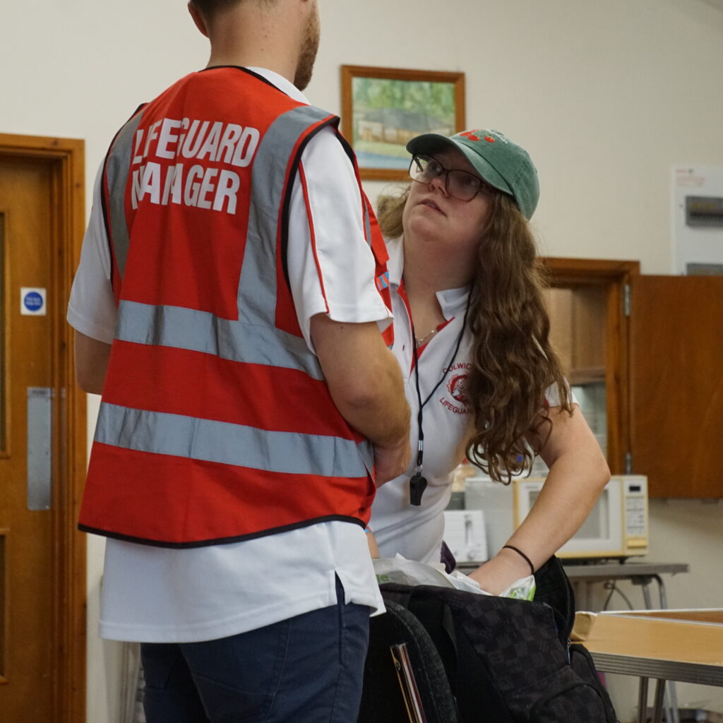 Lifeguards manager talking to lifeguard
