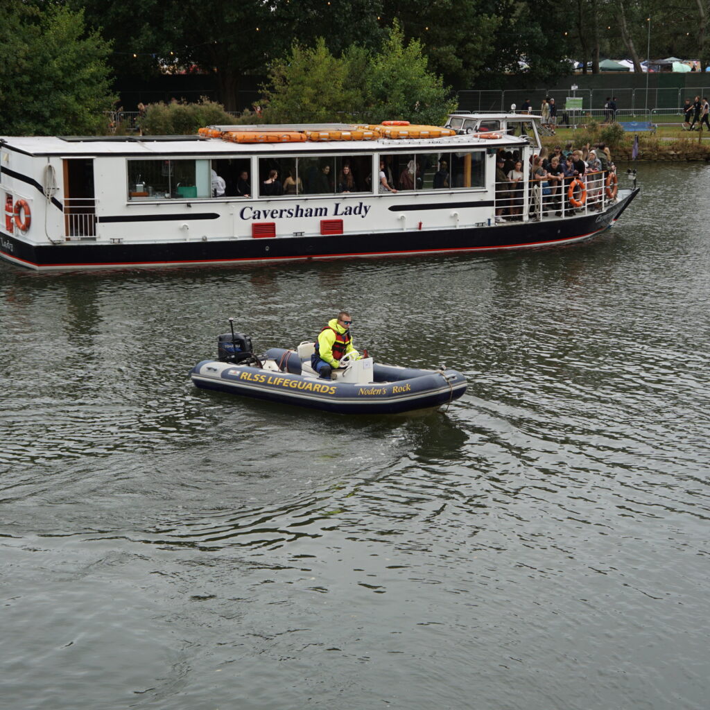Safety boat on river next to Caversham Lady on River Thames