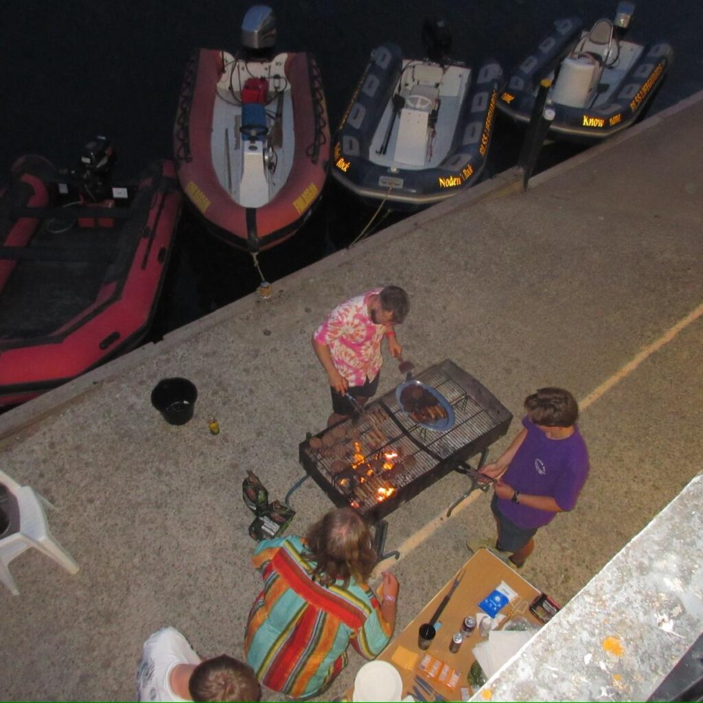 BBQ next to river by safety boats