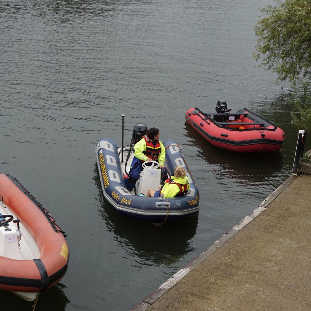 Safety boat with river ferries in background